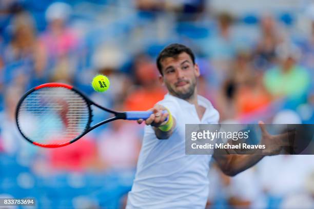 Grigor Dimitrov of Bulgaria returns a shot to Juan Martin Del Potro of Argentina during Day 6 of the Western and Southern Open at the Lindner Family...