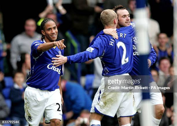 Everton's Steven Pienaar celebrates scoring their second goal with teammates Tony Hibbert and James McFadden