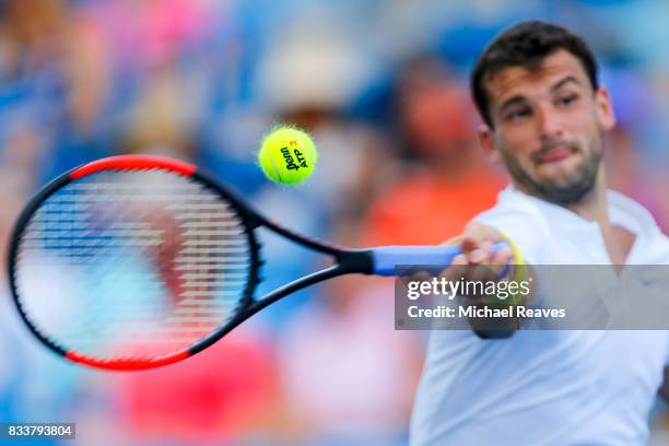 Grigor Dimitrov of Bulgaria returns a shot to Juan Martin Del Potro of Argentina during Day 6 of the Western and Southern Open at the Lindner Family...