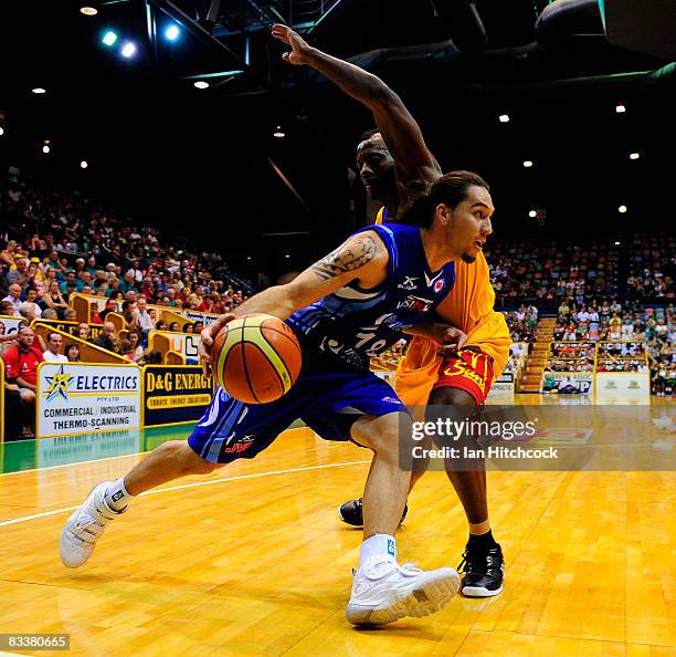 Derick Lowe of the Spirit attemts to drive past Corey Wiliamsof the Crocodiles during the round six NBL match between the Townsville Crocodiles and...