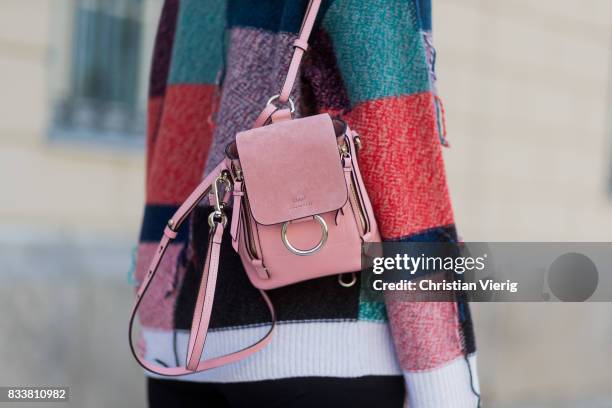 Maria Barteczko wearing patchwork oversized wool sweater Stella McCartney, black skinny jeans Madewell, red buckle boots with studs Givenchy, silver...