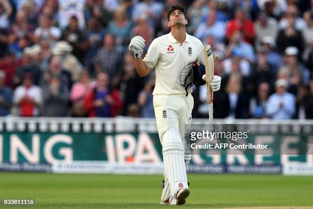 England's Alastair Cook celebrates after reaching his century during play on the opening day of the first Test cricket match between England and the...
