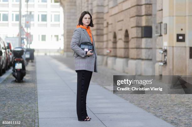 Maria Barteczko wearing orange hoodie Wasted Paris, oversized checked blazer in grey Stella McCartney, wide leg black trousers H&M, black heels...