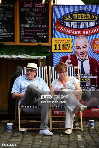 Fringe-goers relax in the sunshine at a coffee stall during the Edinburgh Festival Fringe, on August 17, 2017 in Edinburgh, Scotland. The Fringe is...