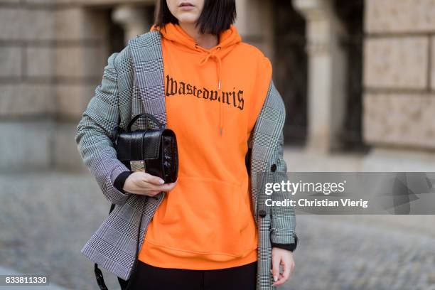 Maria Barteczko wearing orange hoodie Wasted Paris, oversized checked blazer in grey Stella McCartney, wide leg black trousers H&M, black heels...