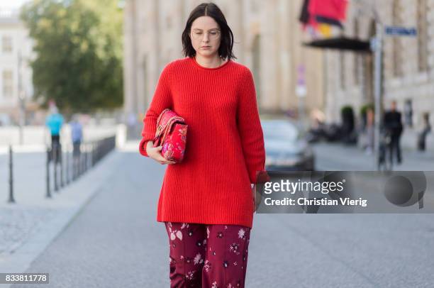 Maria Barteczko wearing red oversized wool sweater The Row, flared floral trousers Valentino, black heels Gianvito Rossi, red GG Marmont flower...