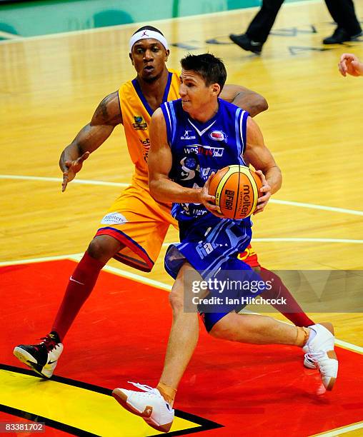 Damian Martin of the Spirit drives past Rosell Ellis of the Crocodiles during the round six NBL match between the Townsville Crocodiles and the...