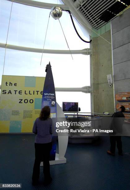 Visitor at the National Space Centre, Leicester, admires a scale model of the Sputnik satellite.