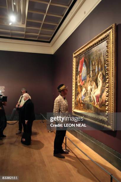 British artist Peter Blake talks to a journalist as artist Bob & Roberta Smith looks at a painting entitled "Diana and Actaeon" by artist Titian at...