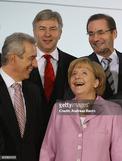 German Chancellor Angela Merkel smiles as Governor of Saxony Stanislaw Tillich , Berlin's Mayor Klaus Wowereit and Brandenburg state Governor...