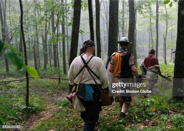 Fighters make their way out of the woods as an abrupt rainstorm hits at Ragnarok XXXII on June 22, 2017. For one week each summer the World has come...