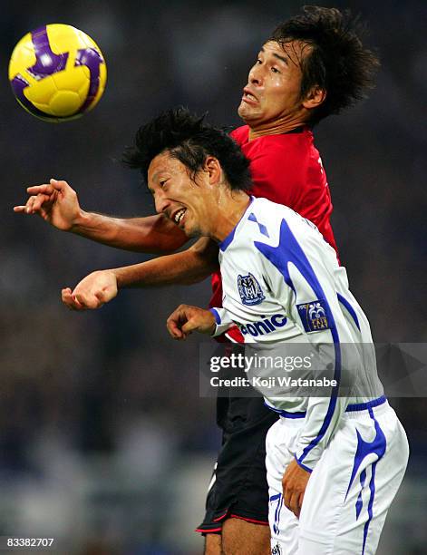 Hideo Hashimoto of Gamba Osaka and Naohiro Takahara of the Urawa Red Diamonds fight for the ball during their AFC Champions League semi-final second...