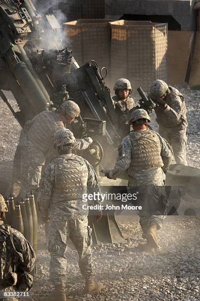 Artillerymen prepare to fire a 155mm Howlitzer at a Taliban position October 22, 2008 from Camp Blessing in the Kunar Province of eastern...