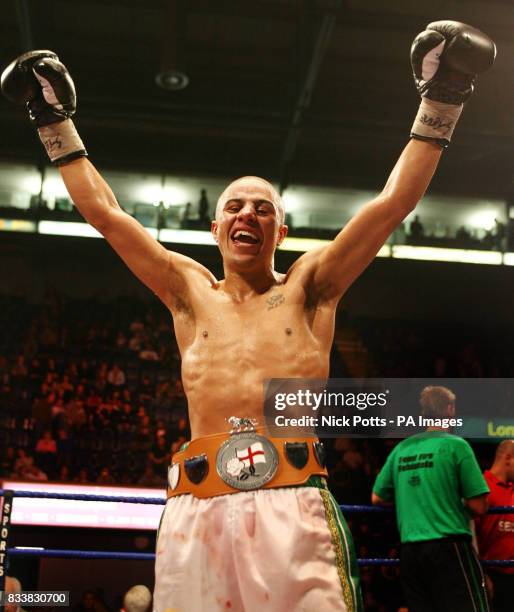 Femi Fehintola celebrates his points victory over Stephen Bell . The Vacant Super-Featherweight Championship of England .