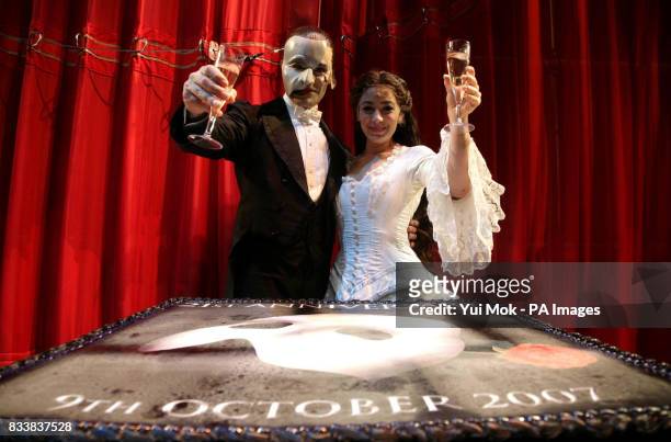 The stars of the musical, Ramin Karimloo as the Phantom and Leila Benn Harris as Christine Daae backstage after the end of the show with a birthday...
