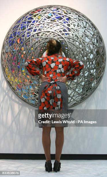 Christie's press officer Zoe Schoon examines Olafur Eliasson's Fivefold Eye, which is expected to fetch between 90,000 and 120,000 when it is sold as...