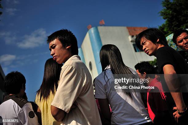 Workers wait to get their defaulted salary in the Junling Branch Factory of Smart Union Group Limited., a Hong Kong listed company and supplier to US...