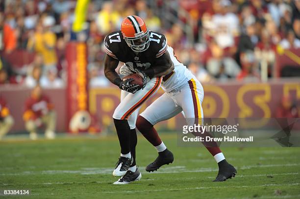Wide receiver Braylon Edwards of the Cleveland Browns gets tackled by cornerback Carlos Rogers of the Washington Redskins on October 19, 2008 at...