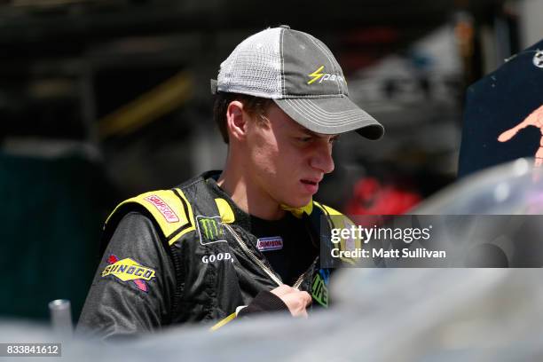 Joey Gase, driver of the Donate Life TN Chevrolet, walks to his car during practice for the NASCAR Xfinity Series Food City 300 at Bristol Motor...