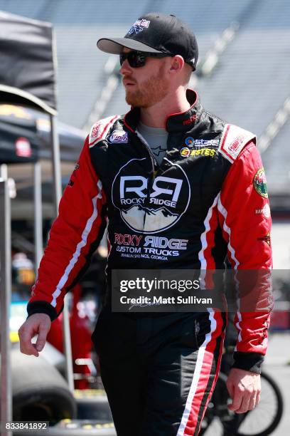 Jeb Burton, driver of the WBWF/State Water Heaters Toyota, walks to his car during practice for the NASCAR Xfinity Series Food City 300 at Bristol...