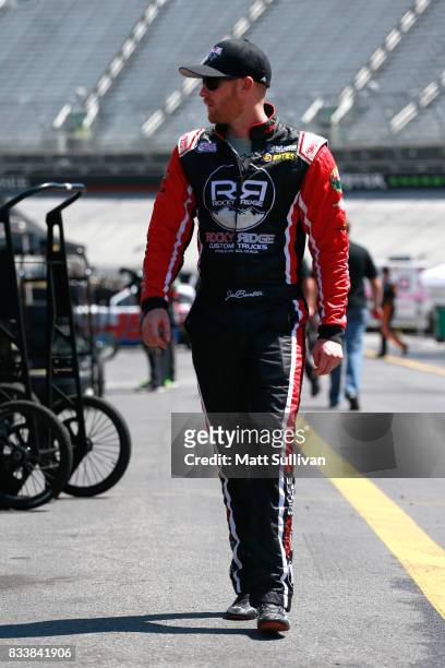 Jeb Burton, driver of the WBWF/State Water Heaters Toyota, walks to his car during practice for the NASCAR Xfinity Series Food City 300 at Bristol...