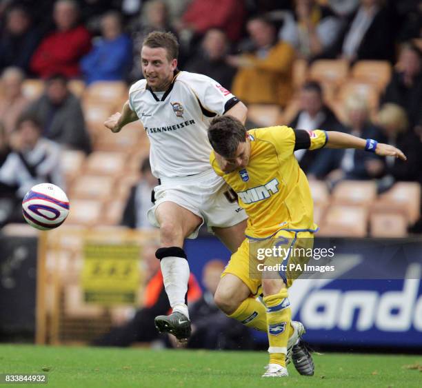 Brighton's Dean Cox loses the ball after being tackled by Port Vale's Robin Hulbert during the Coca-Cola League One match at Vale Park, Stoke-onTrent.