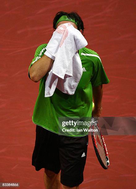 Marcos Baghdatis of Cyprus wipes his face with a towel during the Singles match against Marcel Granollers of Spain during the 3rd Day of the ATP...