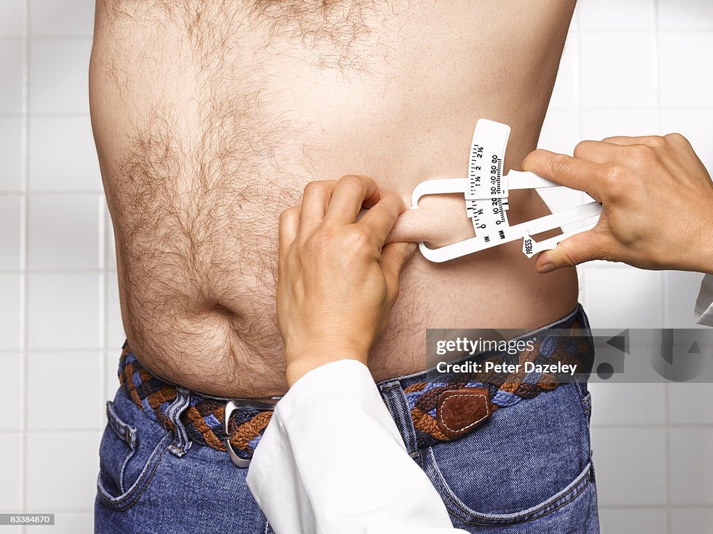 Doctor checking man's BMI