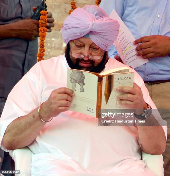 Punjab Chief Minister Captain Amarinder Singh reads the Gulzar book Footprints On Zero Line writing on Partition during the inauguration of Partition...