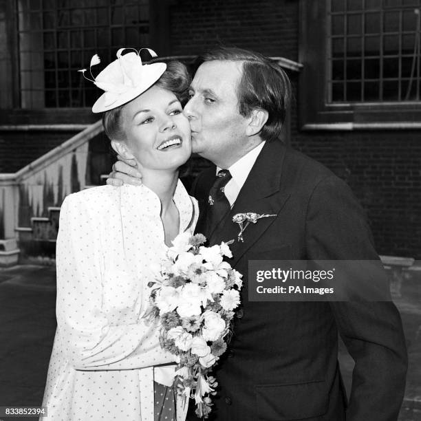 Dame Edna Everage, is nowhere in sight as her creator, actor Barry Humphries kisses his bride, 30 year old artist Diane Millstead, after their...