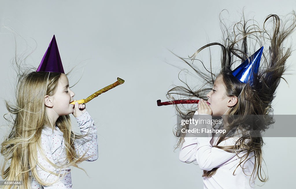 Portrait of two girls wearing party hats