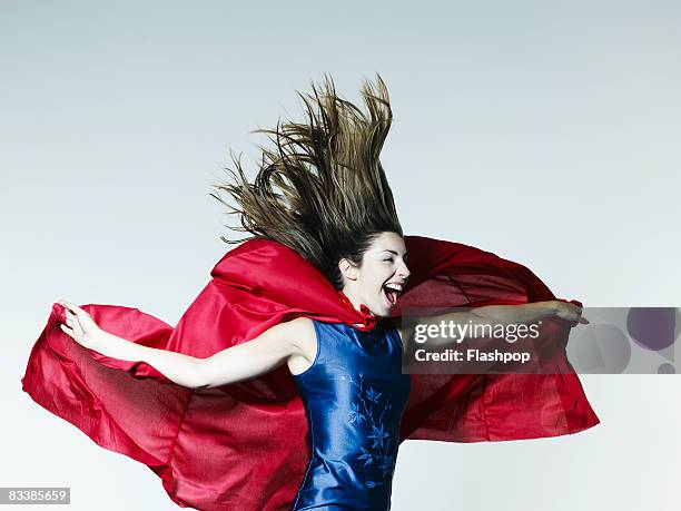 portrait of woman dressed as a superhero - heldin stock-fotos und bilder