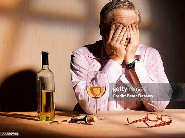 exhausted man with wine - alcoholisme stockfoto's en -beelden