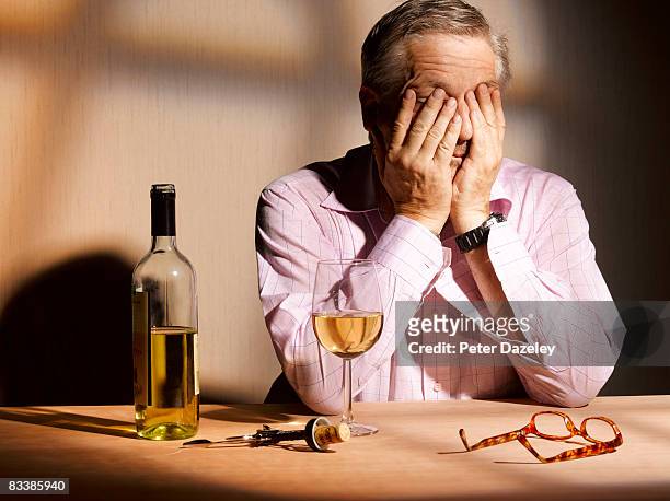 exhausted man with wine - alcohol abuse stock pictures, royalty-free photos & images