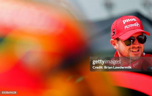 Michael Annett, driver of the Pilot Flying J Chevrolet, stands by his car during practice for the NASCAR Xfinity Series Food City 300 at Bristol...