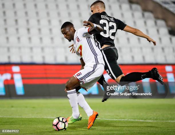 Stopira of Videoton is challenged by Uros Djurdjevic of Partizan during the UEFA Europa League Qualifying Play-Offs round first leg match between...