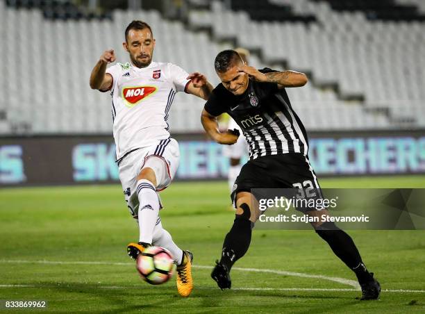 Uros Djurdjevic of Partizan in action against Attila Fioala of Videoton during the UEFA Europa League Qualifying Play-Offs round first leg match...