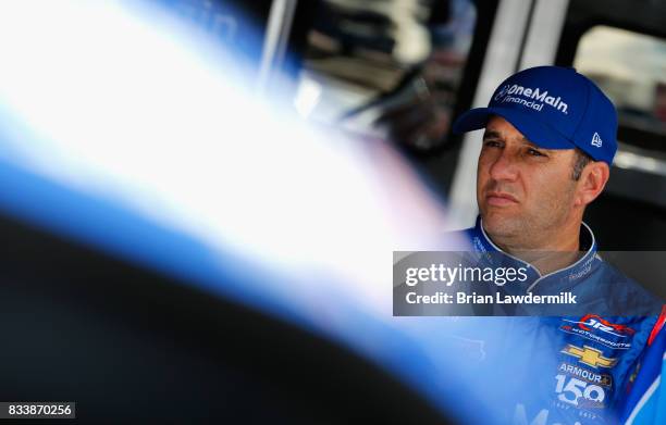 Elliott Sadler, driver of the OneMain Financial Chevrolet, stands in the garage during practice for the NASCAR Xfinity Series Food City 300 at...