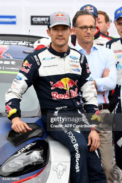 German Justice Minister Heiko Maas pose for a picture with French Rally driver Sebastian Ogier during the start of the Rally of Germany in...