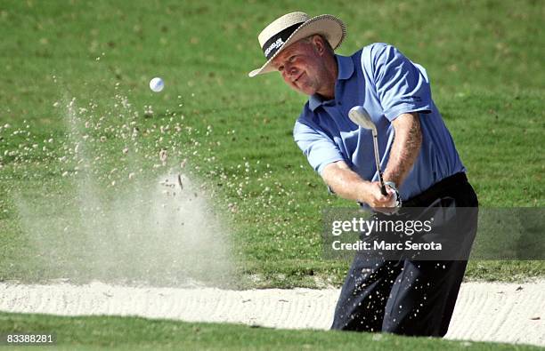 Denis Watson hits out of the sand trap on the first hole during the final round of the Champions Tour Administaff Small Business Classic at the...