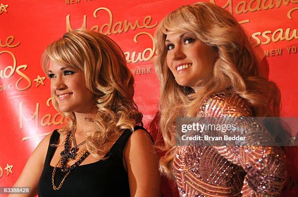 Singer Carrie Underwood poses with her wax figure during the unveiling at Madame Tussauds on October 22, 2008 in New York City.