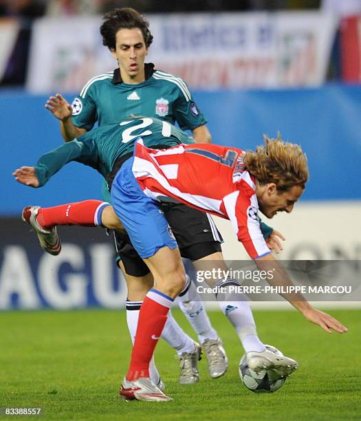 Atletico de Madrid's Uruguayan forward Diego Forlan vies with Liverpool's Brazilian midfielder Lucas Leiva during their Champions League football...