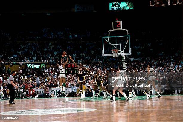 Dennis Johnson of the Boston Celtics shoots a jump shot against Magic Johnson of the Los Angeles Lakers during Game Two of the 1984 NBA FInals played...