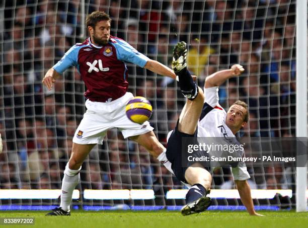 West Hamn United's Matthew Upson and Bolton Wanderers' Kevin Davies battle for the ball