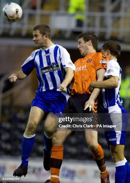 Dundee United's Jon Daly jumps for the ball with Kilmarnock's Frazer Wright during the Clydesdale Bank Scottish Premier League match at Tannadice...
