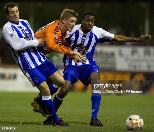 Dundee United's Jordan Robertson is stopped by Kilmarnock's Rhian Dodds and Simon Ford during the Clydesdale Bank Scottish Premier League match at...