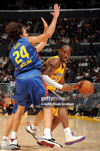 Kobe Bryant of the Los Angeles Lakers moves the ball against Victor Sada of Regal FC Barcelona during the game at Staples Center on October 18, 2008...