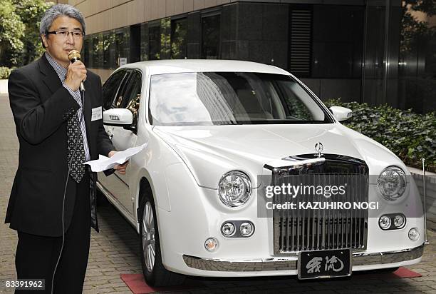 Japan's auto maker Mitsuoka Motor vice president Takanari Kawamura introduces the company's new model "Galue limousine S50", which was based on the...
