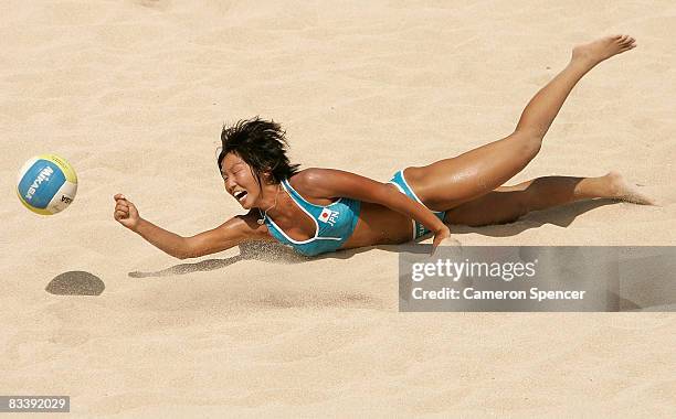 Mutsumi Ozaki of Japan in action with Ayumi Kusano of Japan during their womens beach volleyball match against Devota Saveriana Rahawarin and Ayu...