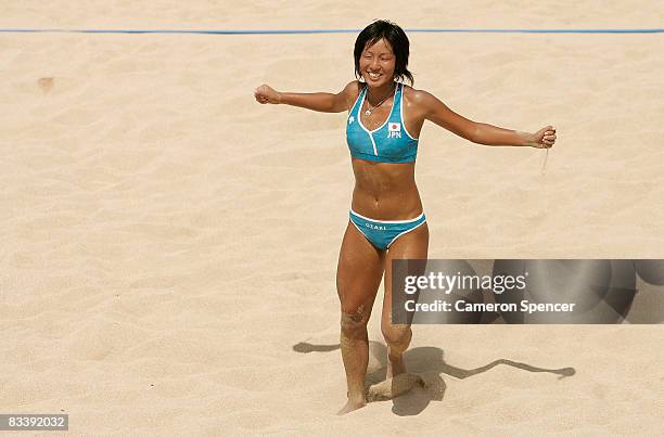 Mutsumi Ozaki of Japan celebrates a point with Ayumi Kusano of Japan during their womens beach volleyball match against Devota Saveriana Rahawarin...